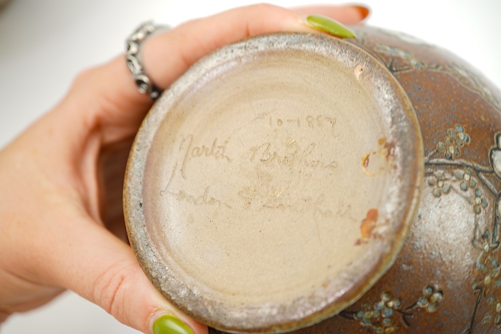 Martin Brothers: A stoneware jug decorated with flowers